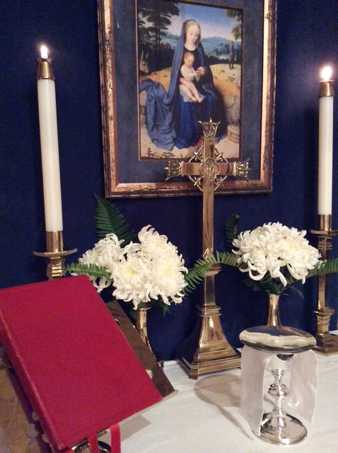 Chapel altar with cross candles and flowers