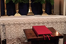 Chapel altar with cross candles and Bible