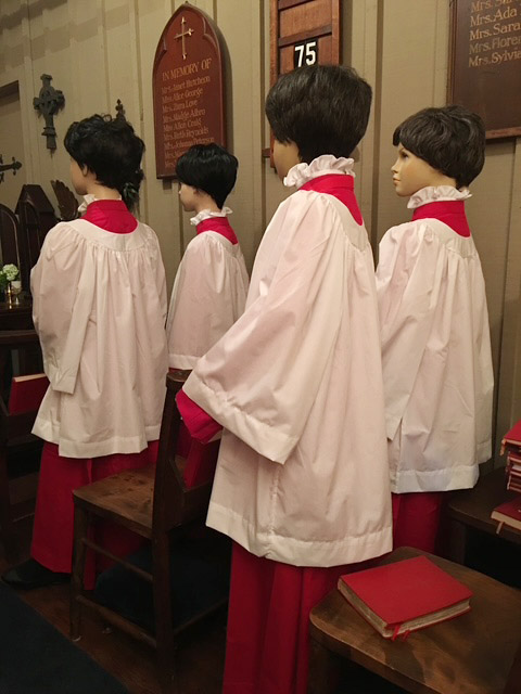 Figures of children standing in the chapel