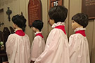 Figures of children standing in the chapel
