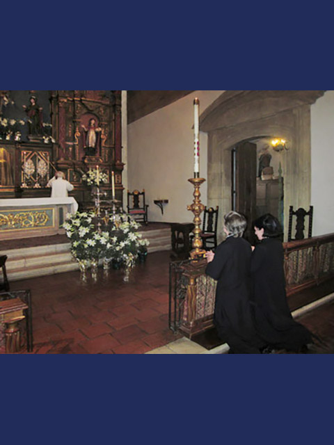 Two women kneeling and praying